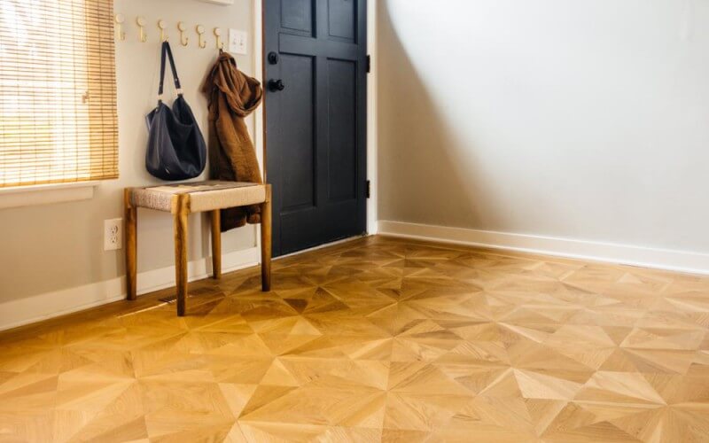 A parquet wood floor with a brass border inlay.