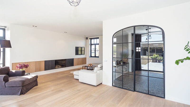 A light white hardwood floor in a living room.