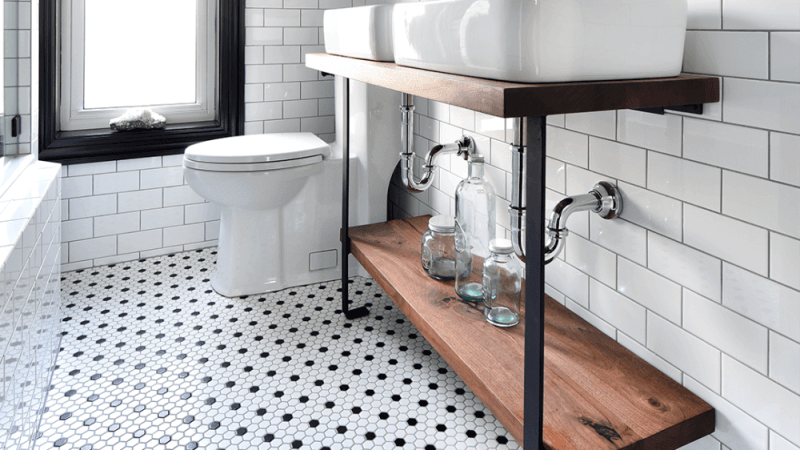 An industrial bathroom vanity made out of metal and salvaged black walnut wood.