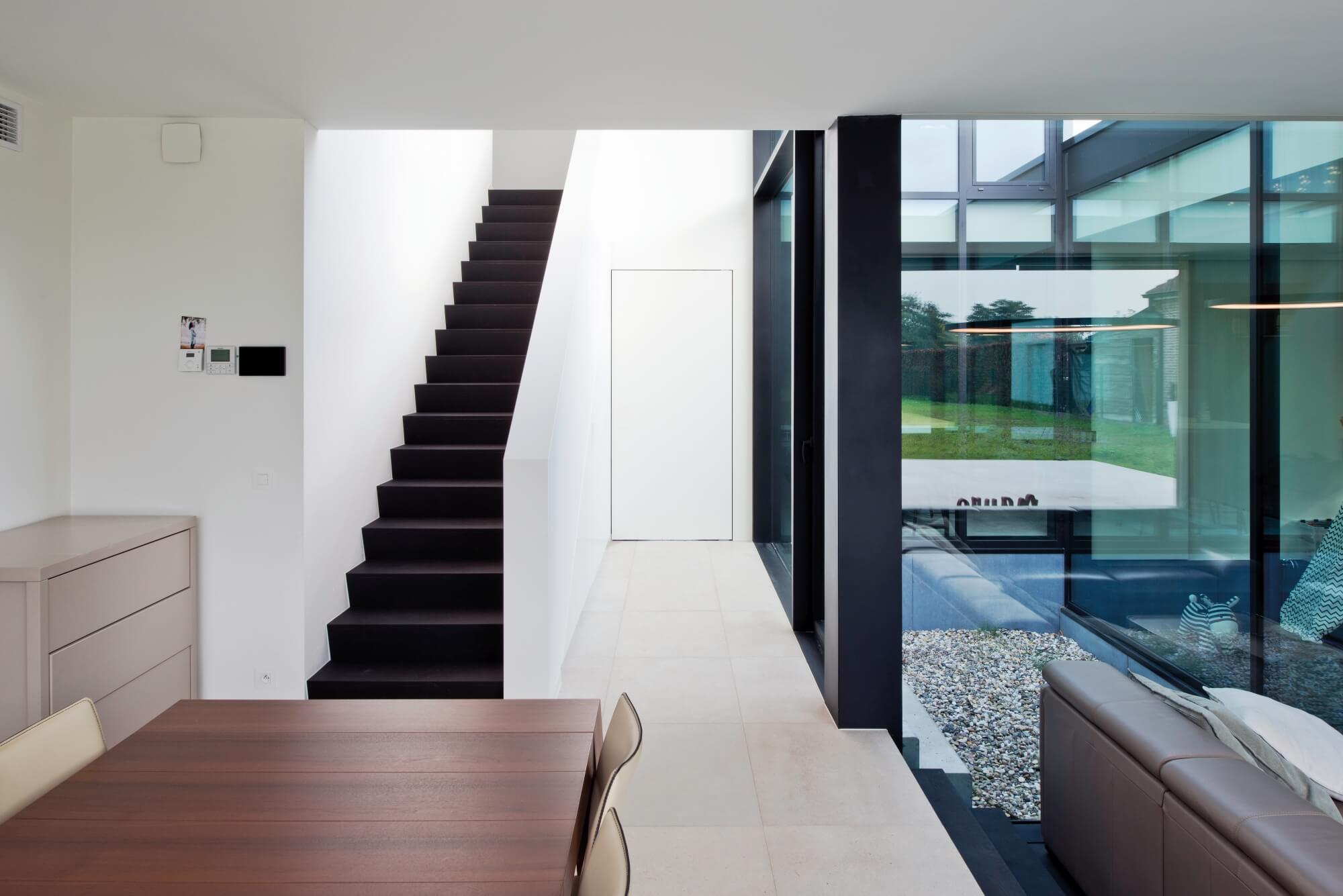 Dark stair treads leading out of a kitchen.