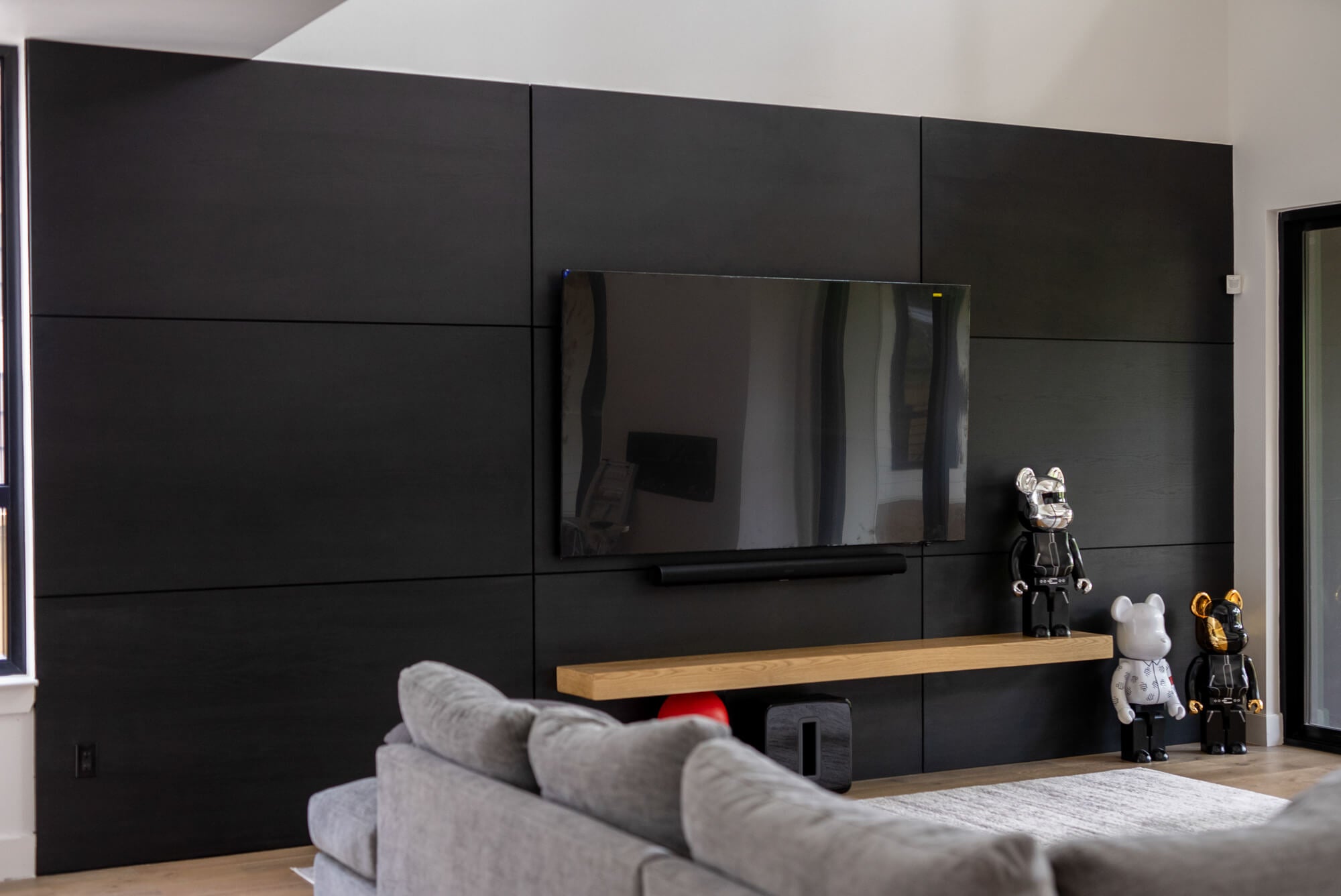 A white oak veneer paneled wall stained with black Rubio Moncoat products.