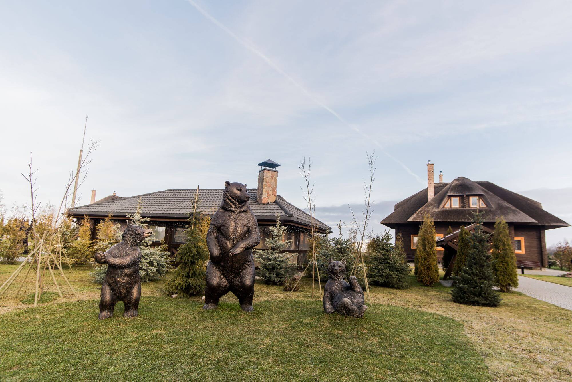 Three bear statues sit outside resort style property where all the wood is finished with Rubio Monocoat.