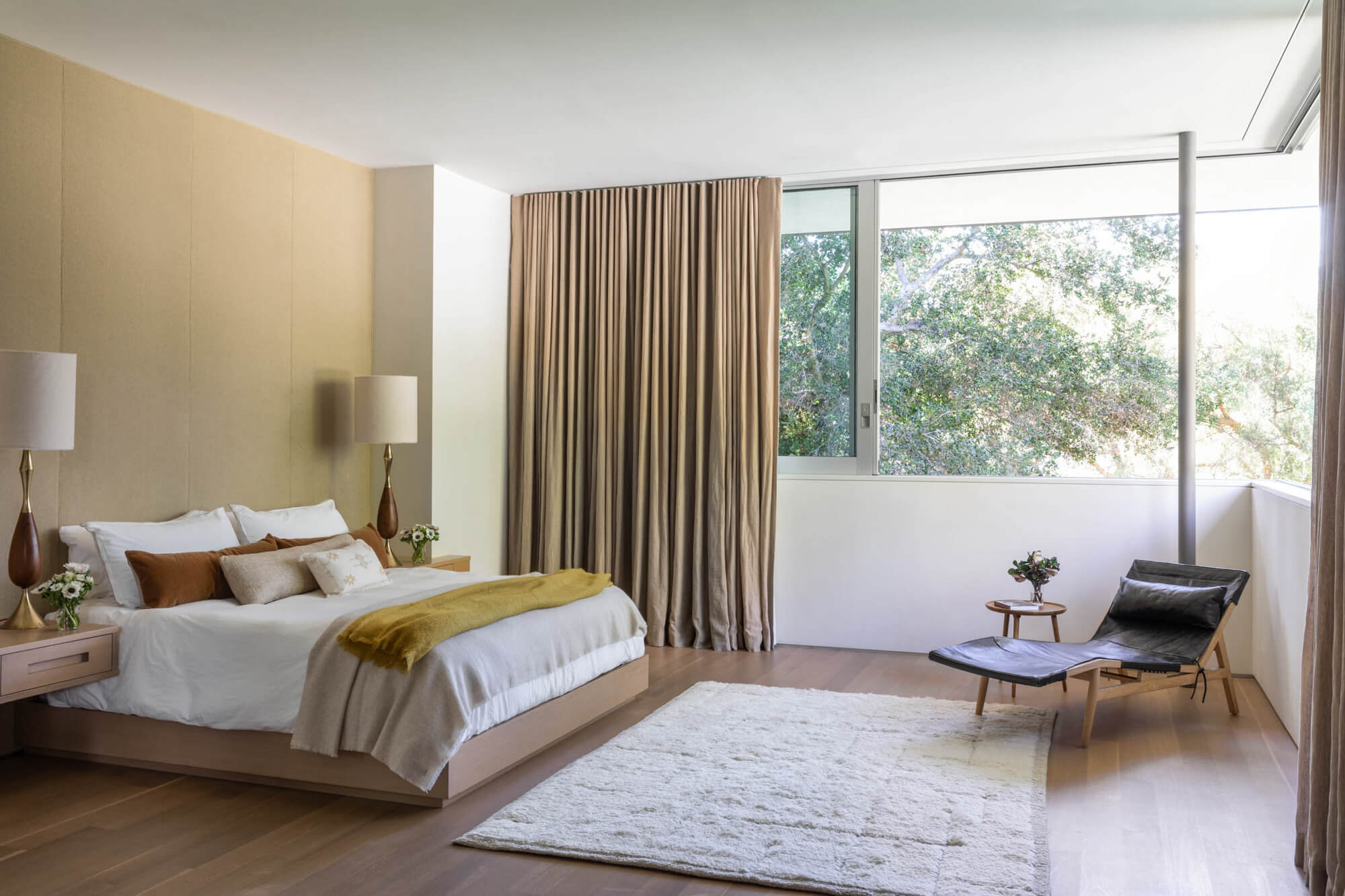 The primary bedroom in the Oakdell Residence features hardwood flooring finished with Rubio Monocoat hardwax oil.