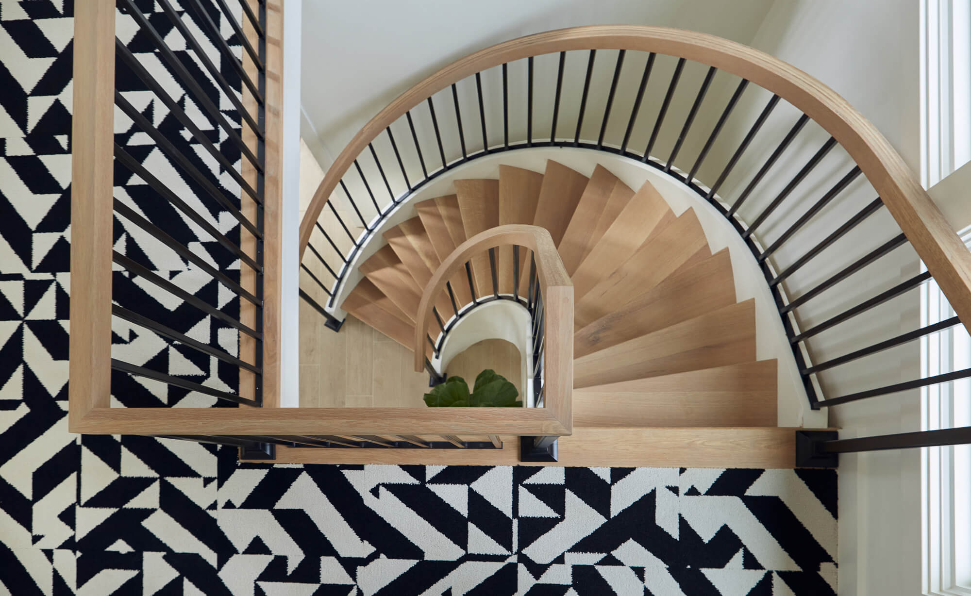 Spiraling wood stair case with natural wood.