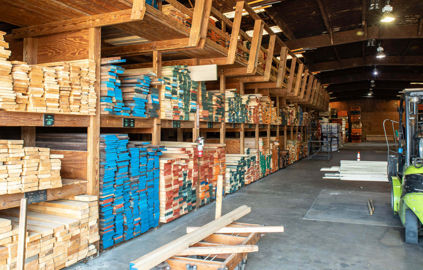 A lumberyard with multiple wood species laid out for selection