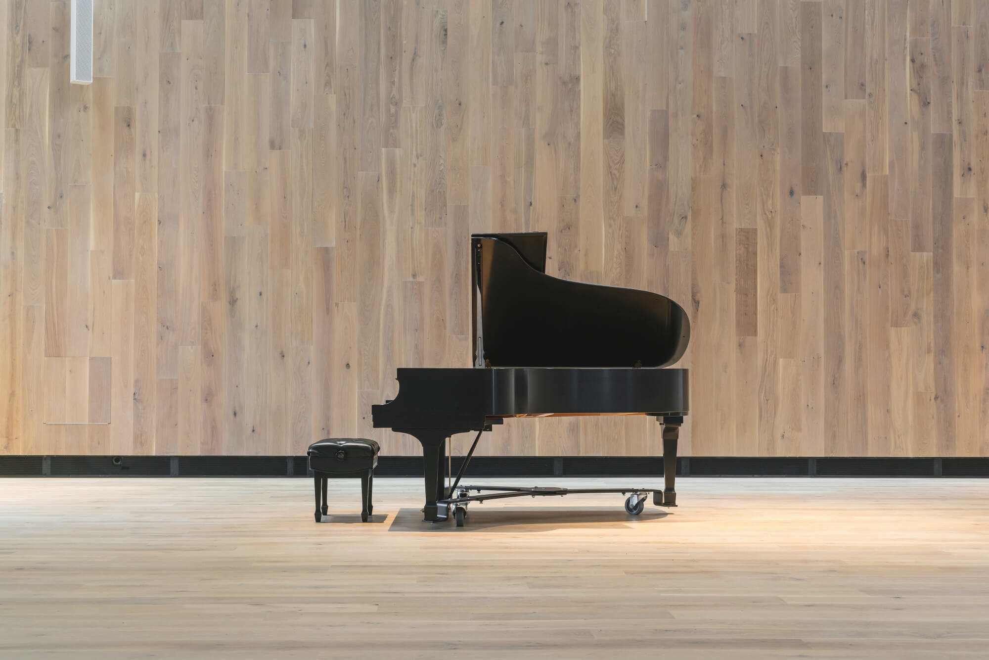 A grand piano in the middle of the Berwick Hall.