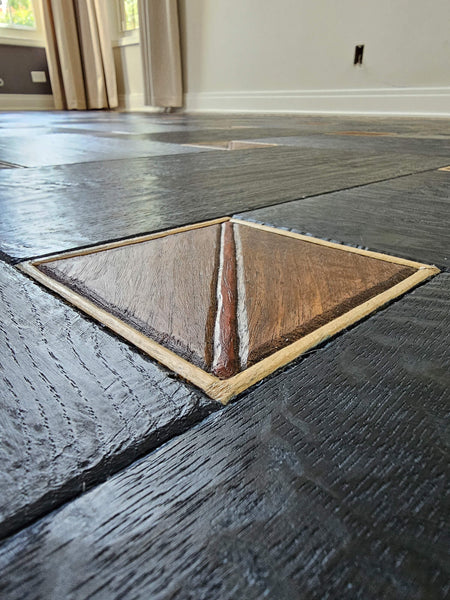 Detail image of the hand finished walnut, bubinga, and maple squares apart of a basketweave pattern.