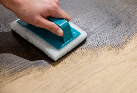 Applying Oil Plus 2C wood finish to a white oak table top using a white applicator pad