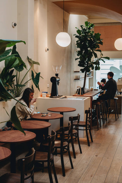 People enjoying coffee at a warm, welcoming coffee shop in Brussels, Belgium.