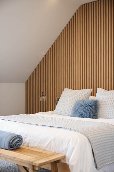 A bedroom accent wall made from white oak and finished with Rubio Monocoat Oil Plus 2C interior wood finish. 