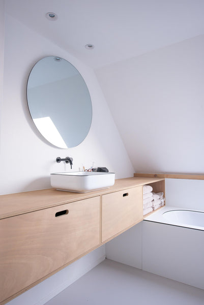 A minimalist bathroom with a floating wood vanity finished with Rubio Monocoat Oil Plus 2C hardwax oil wood finish.