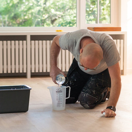 Rubio Monocoat Deep Cleaner being prepared in a bucket to clean a wood floor