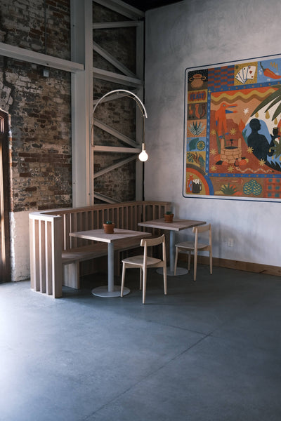 A modern restaurant with light-toned wood furniture made from alder and finished using Oil Plus 2C White.