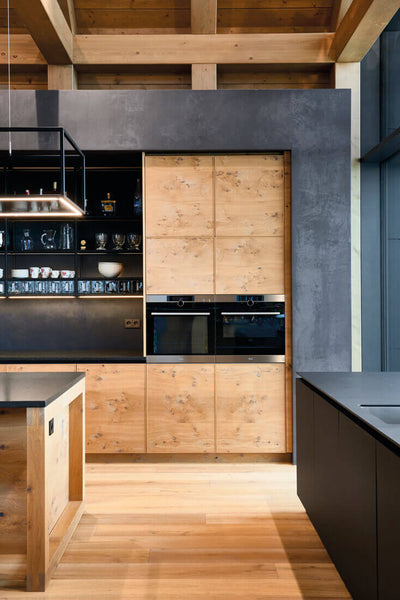 Natural oak wood cabinets and oak wood floor in kitchen.