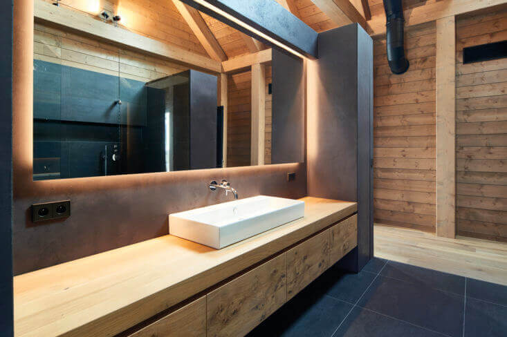 Master bathroom with wood paneling and tile.